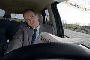 driver_on_cell_and_reading_newspaper